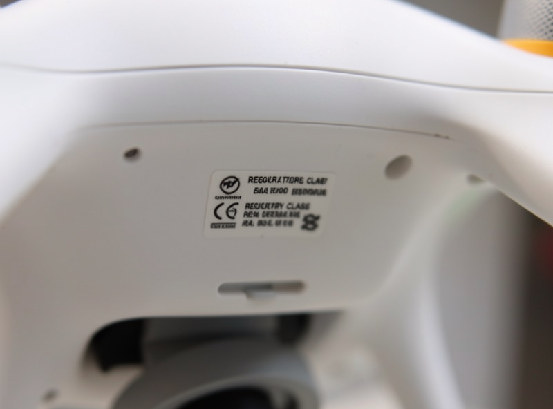 Close-up of a sub-250 gram drone showing a C0 class mark label on its underside