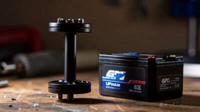 FPV brushless motor beside a 6S LiPo battery on a workbench