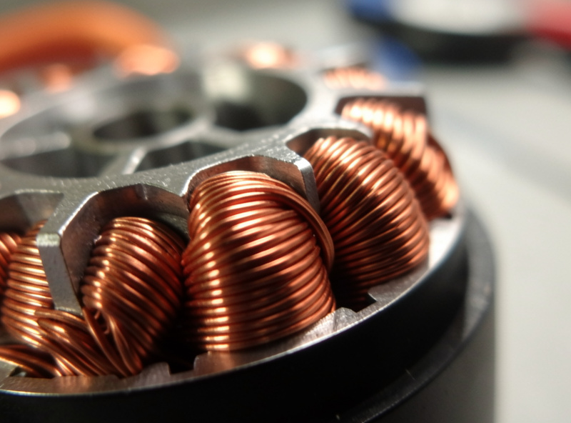Close-up of FPV motor windings showing copper wire turns around the stator