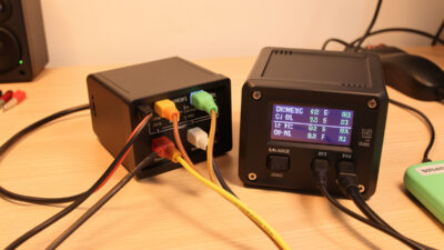Balance lead and main connector both plugged into a LiPo charger showing matched per-cell voltages